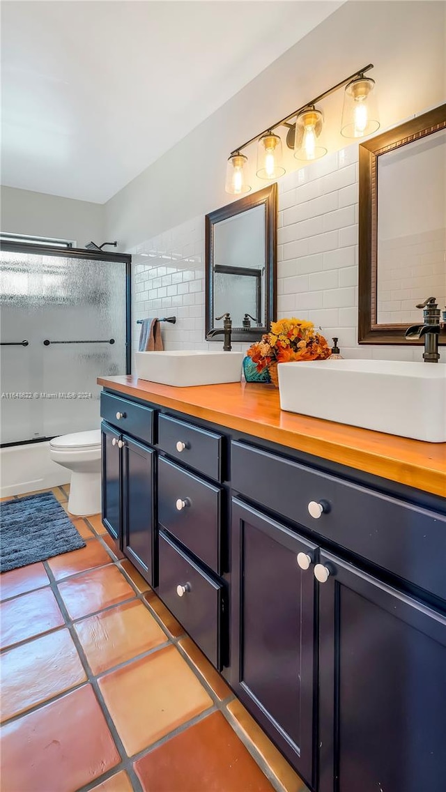 bathroom featuring tile patterned floors, walk in shower, toilet, and vanity