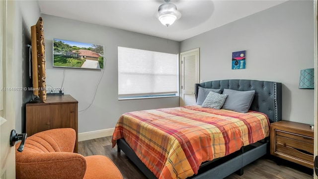 bedroom with ceiling fan and dark hardwood / wood-style floors