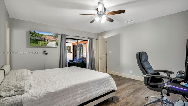 bedroom featuring wood-type flooring, ceiling fan, and access to outside