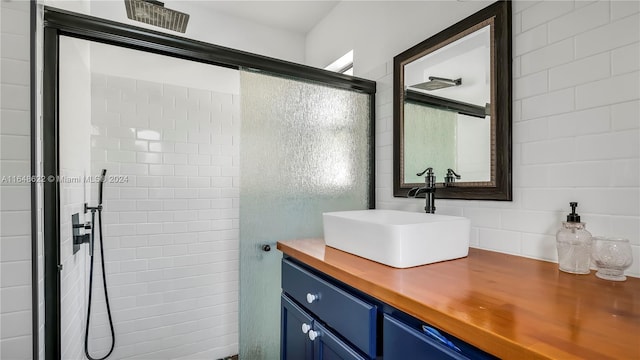 bathroom featuring an enclosed shower and vanity