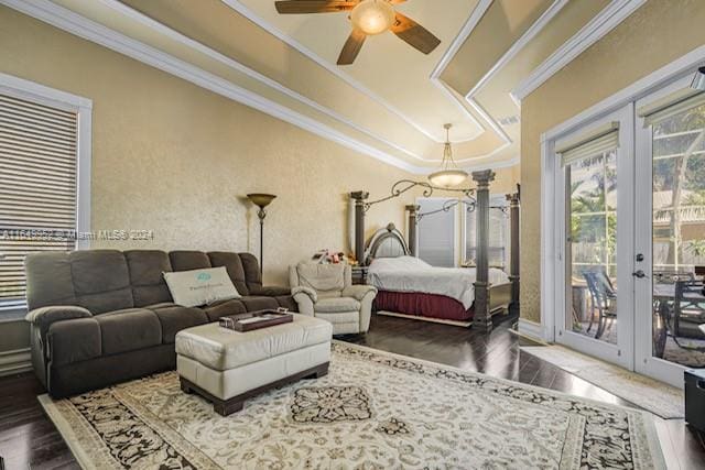 bedroom with hardwood / wood-style flooring, crown molding, french doors, a tray ceiling, and access to exterior