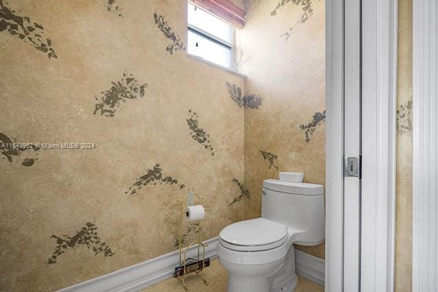 bathroom featuring toilet and tile patterned flooring