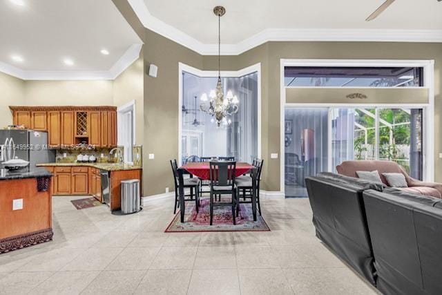 tiled dining room with ornamental molding and a chandelier