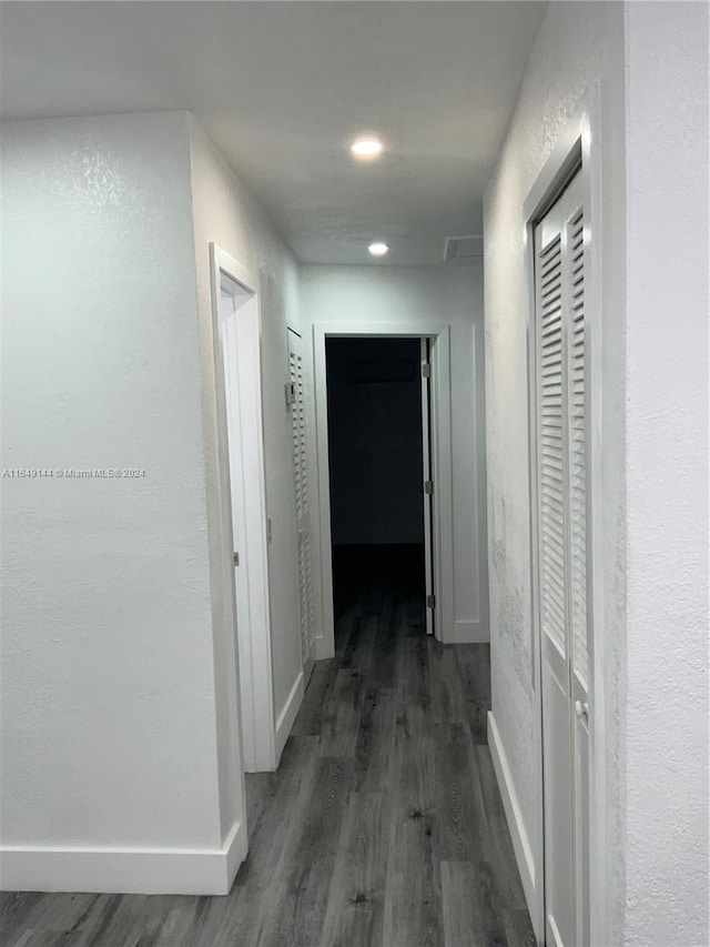 hallway with dark wood-type flooring