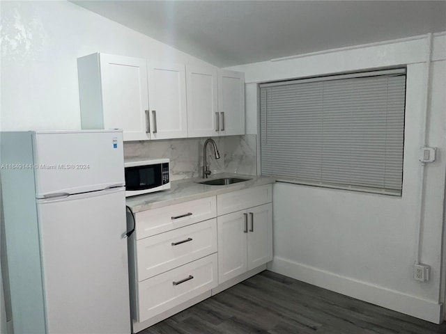 kitchen featuring sink, white appliances, white cabinetry, and decorative backsplash