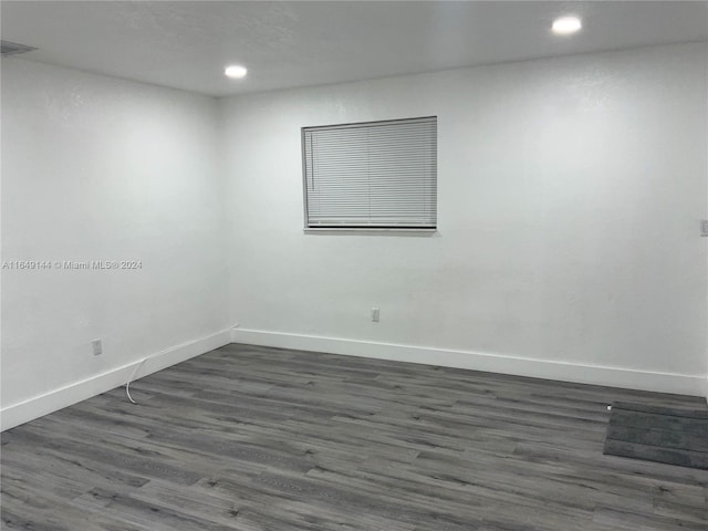 spare room featuring dark wood-type flooring