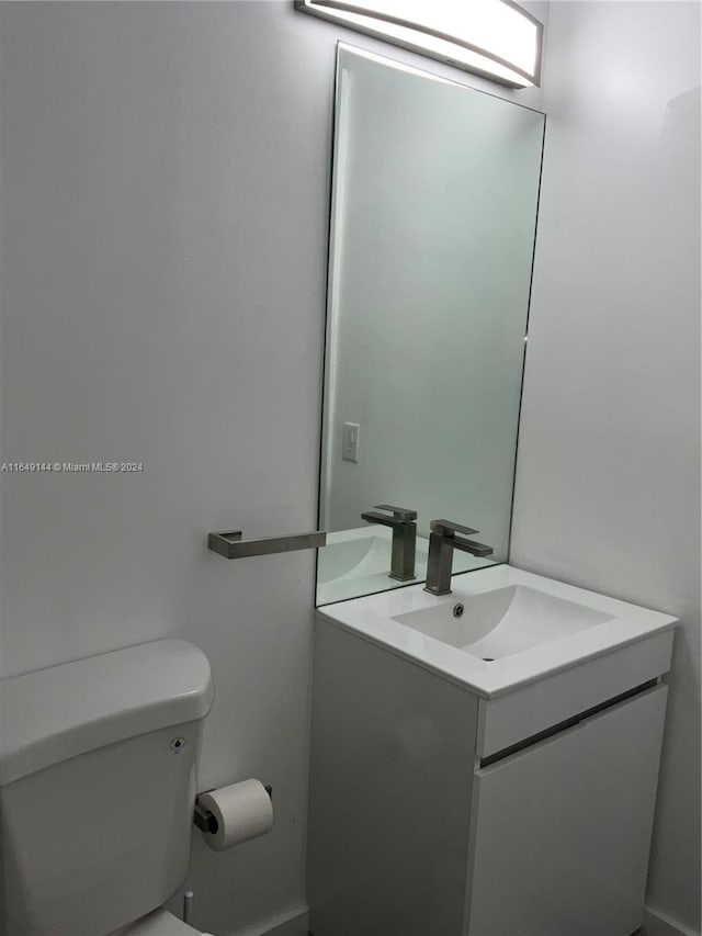 bathroom featuring vanity and toilet