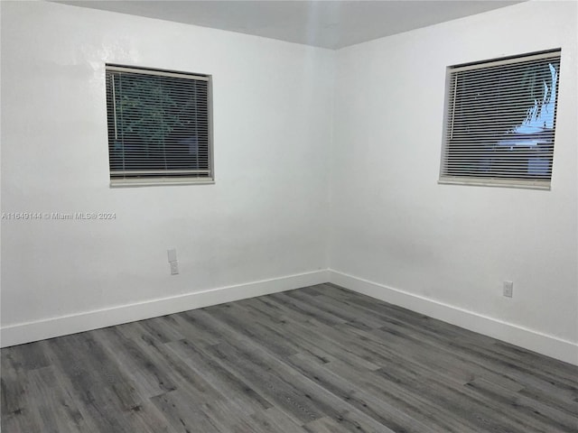 empty room featuring dark wood-type flooring