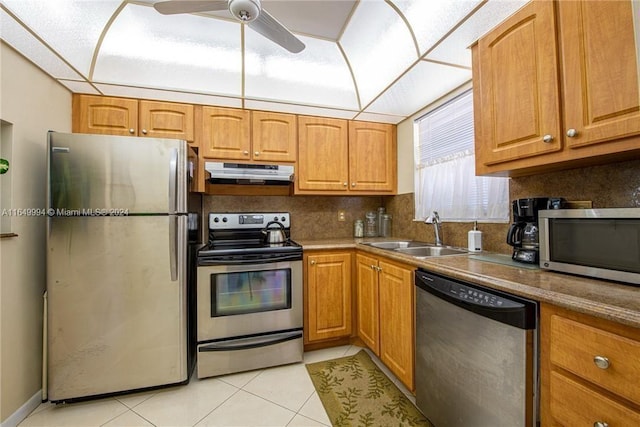 kitchen featuring backsplash, sink, ceiling fan, appliances with stainless steel finishes, and light tile patterned flooring