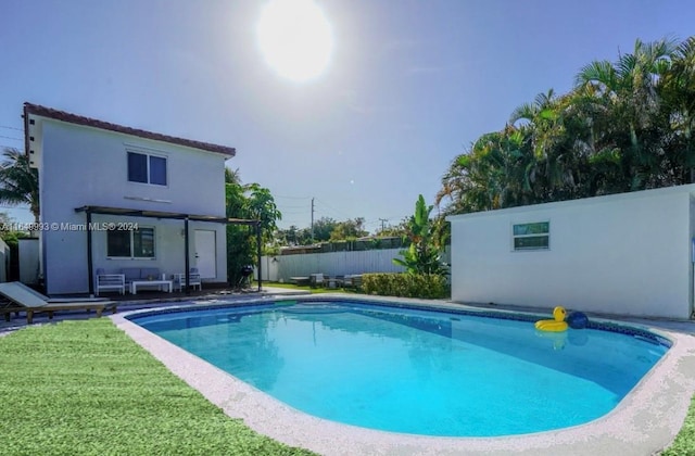 view of pool featuring a patio and a lawn