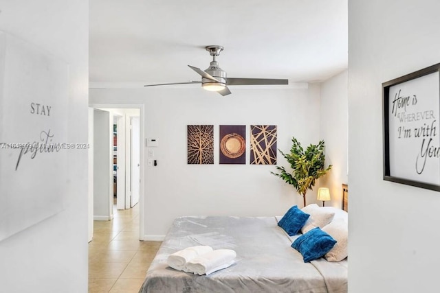 tiled bedroom featuring ceiling fan