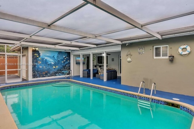 view of swimming pool featuring a lanai and a patio area