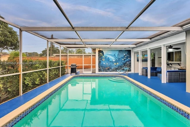 view of pool with ceiling fan, a patio area, and glass enclosure