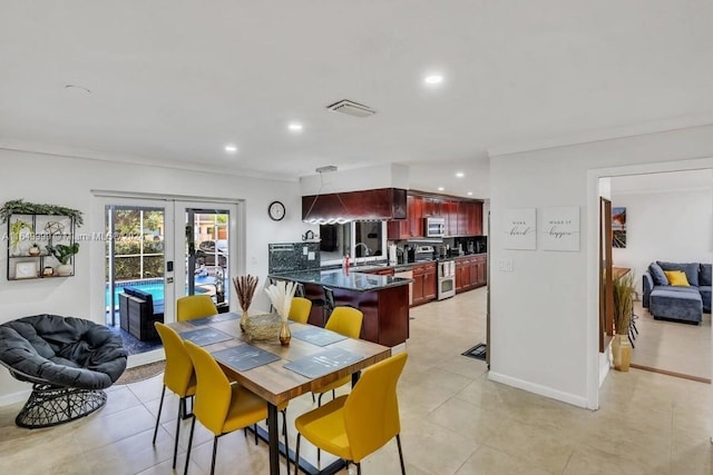 dining space featuring crown molding, sink, light tile patterned flooring, and french doors