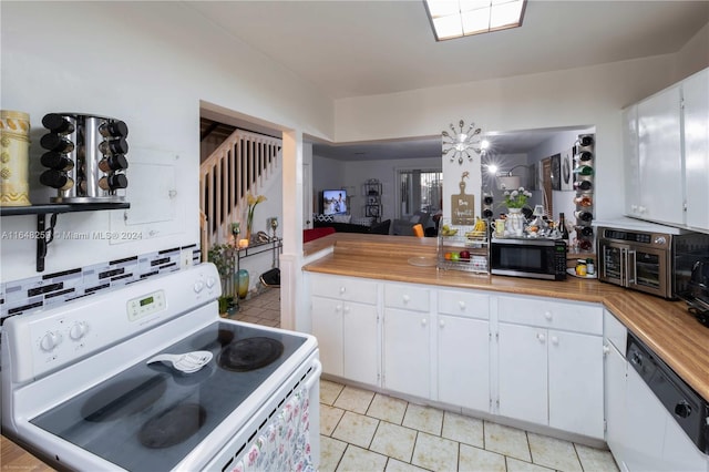 kitchen with white appliances, white cabinetry, butcher block countertops, light tile patterned flooring, and tasteful backsplash