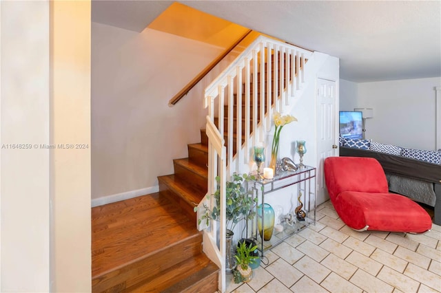 stairs with hardwood / wood-style flooring