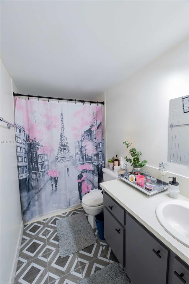 bathroom with vanity, toilet, and tile patterned floors