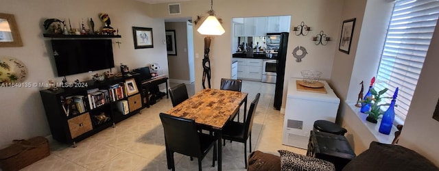 dining area featuring light tile patterned flooring