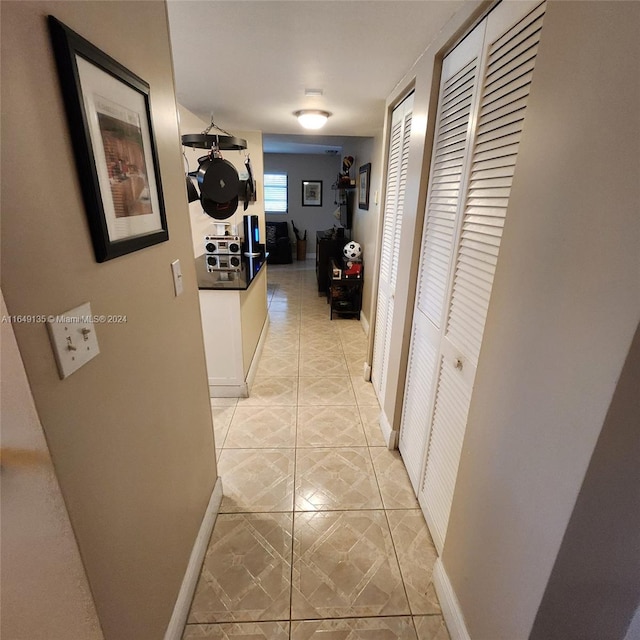 corridor with light tile patterned floors