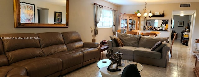 tiled living room featuring a chandelier