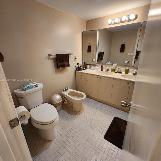 bathroom featuring tile patterned flooring, vanity, toilet, and a bidet