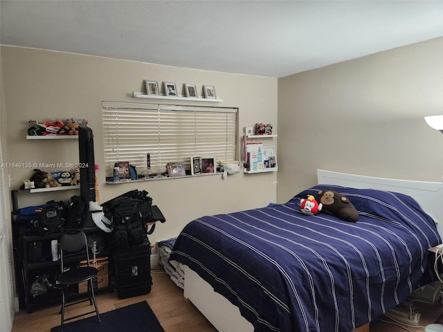 bedroom with hardwood / wood-style floors