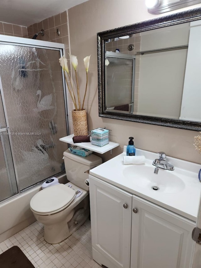 full bathroom featuring tile patterned flooring, vanity, toilet, and enclosed tub / shower combo