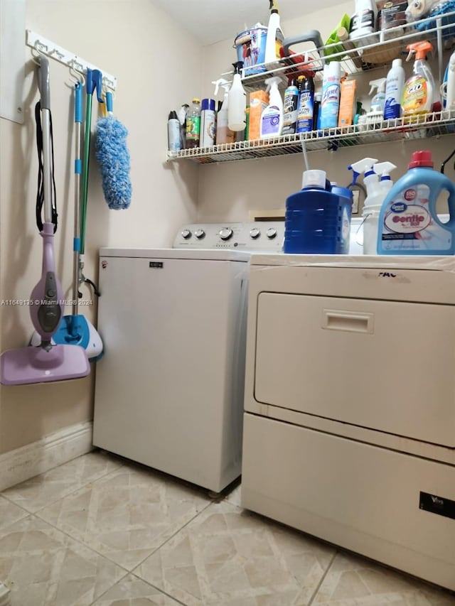 washroom featuring washing machine and clothes dryer and light tile patterned floors