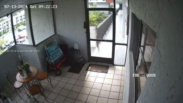 doorway to outside featuring tile patterned flooring