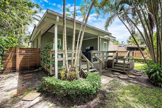 rear view of property with a wooden deck