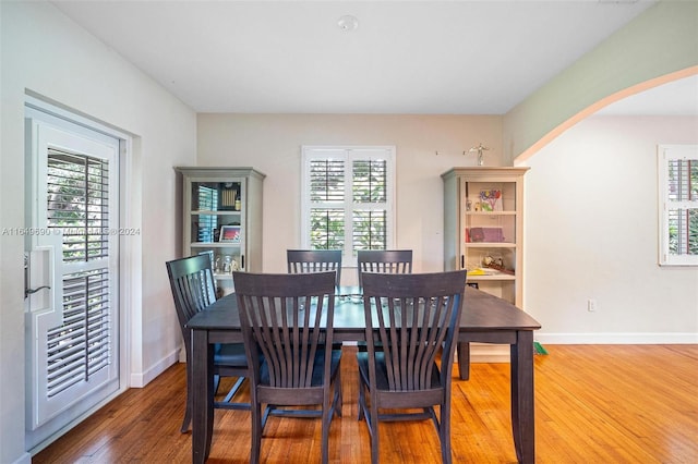 dining area with wood-type flooring and plenty of natural light