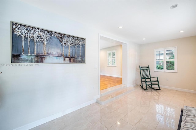 hall with light tile patterned floors