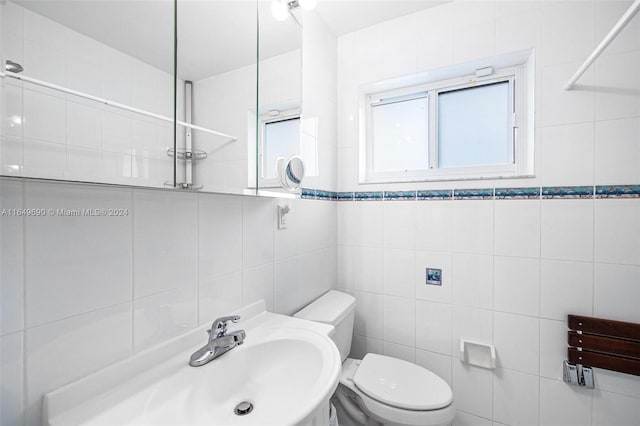 bathroom with tile walls and toilet