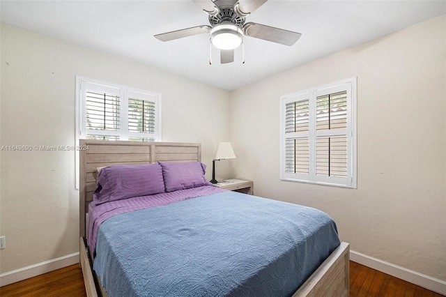 bedroom with ceiling fan and dark hardwood / wood-style floors