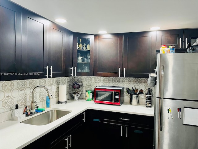 kitchen with sink, tasteful backsplash, and stainless steel refrigerator