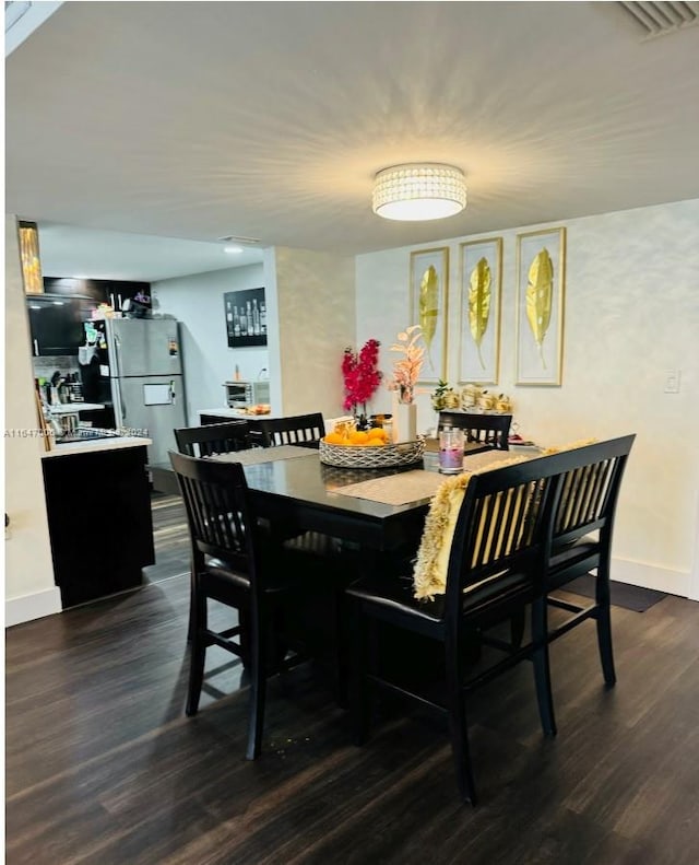 dining space featuring dark wood-type flooring