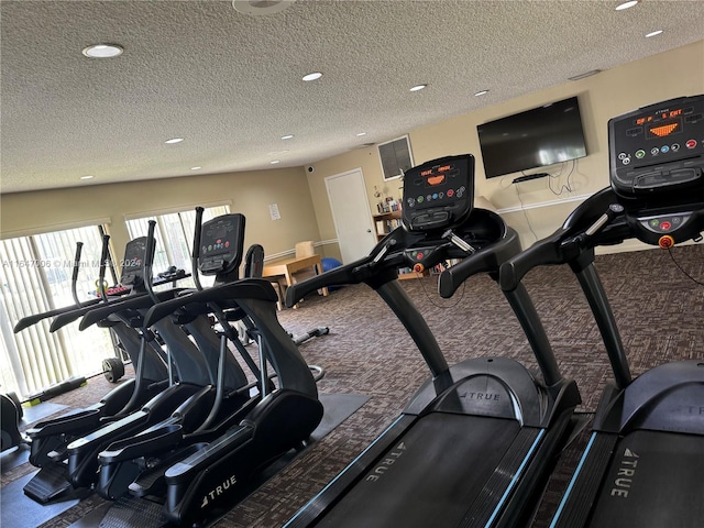 exercise room featuring a textured ceiling