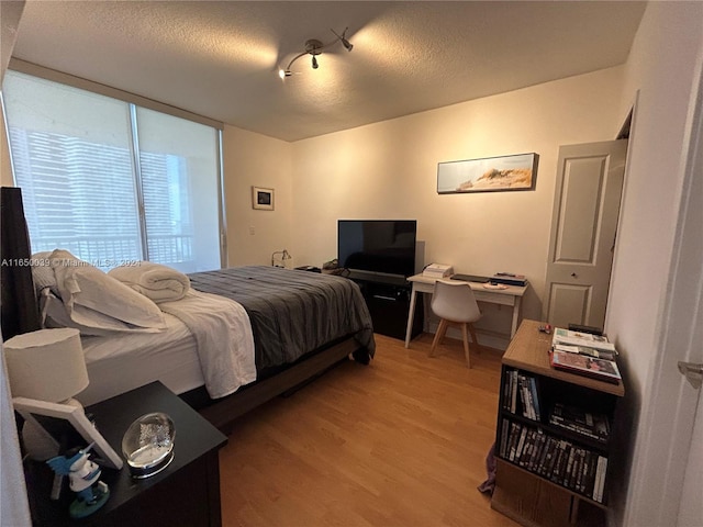 bedroom featuring a textured ceiling and hardwood / wood-style floors