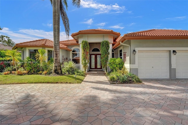 mediterranean / spanish-style house with a garage