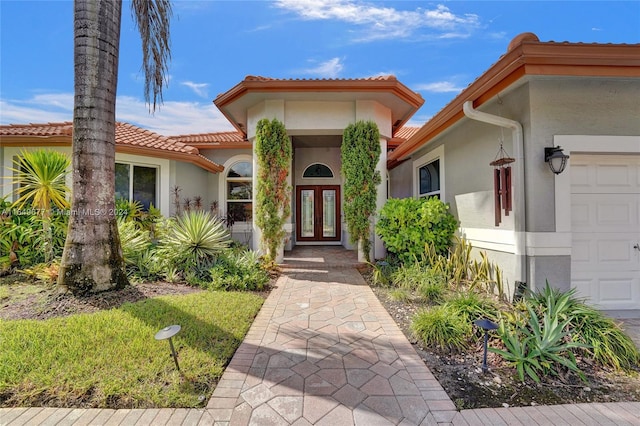 view of front facade with a garage and french doors