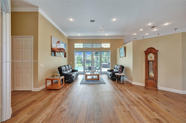 interior space featuring crown molding, french doors, a textured ceiling, and light hardwood / wood-style flooring