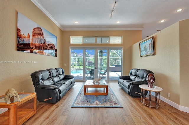 living room featuring a textured ceiling, french doors, light hardwood / wood-style floors, ornamental molding, and rail lighting