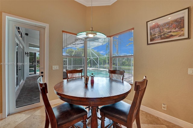 dining space with ornamental molding