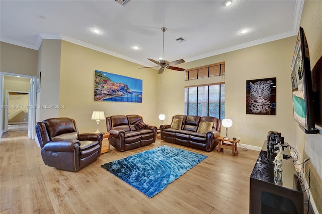 living room featuring ceiling fan, ornamental molding, and light hardwood / wood-style flooring