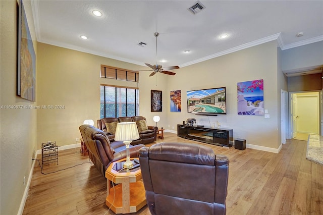 living room featuring ceiling fan, ornamental molding, and light hardwood / wood-style flooring