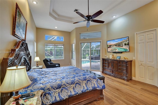 bedroom with light hardwood / wood-style flooring, ceiling fan, a closet, and access to outside