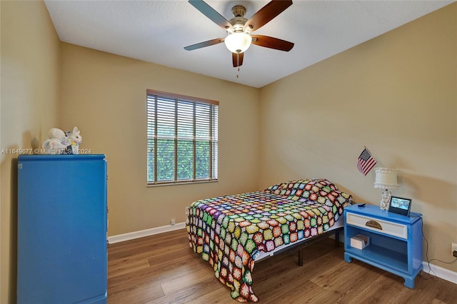 bedroom with wood-type flooring and ceiling fan