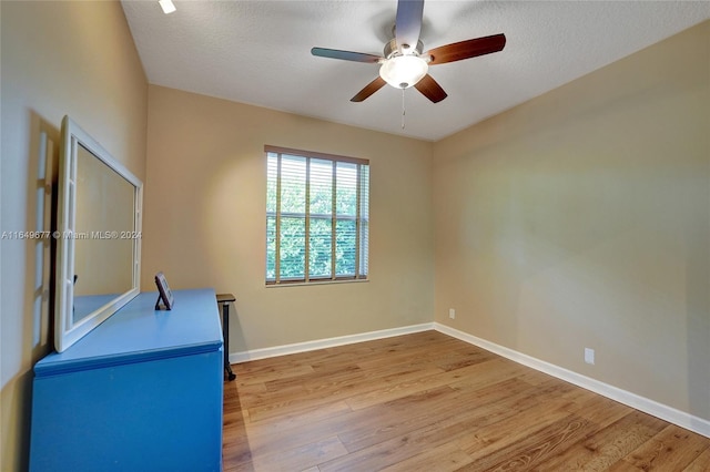 interior space featuring a textured ceiling, ceiling fan, and hardwood / wood-style flooring