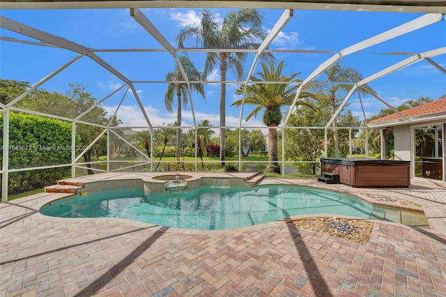 view of swimming pool featuring glass enclosure, a hot tub, and a patio