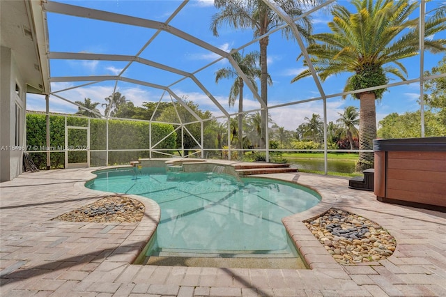 view of pool featuring an outdoor hot tub, a patio area, and a lanai